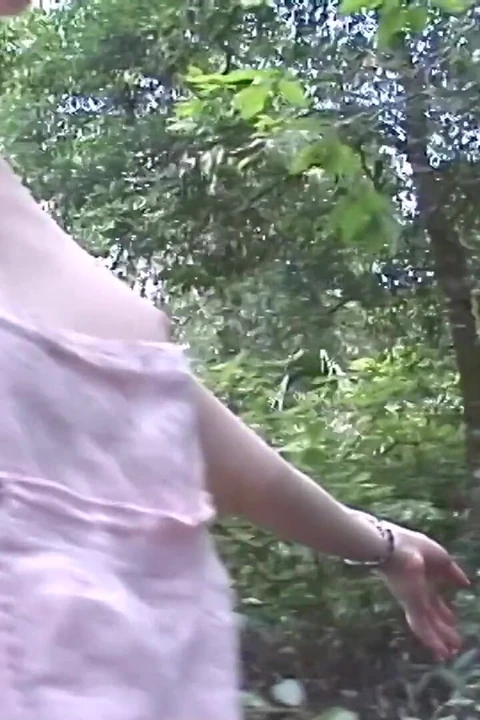 Sexy redhead streaks naked in a park