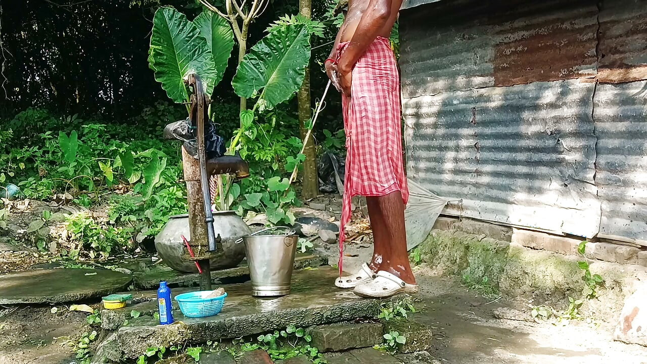 Desi young man bath Open place.