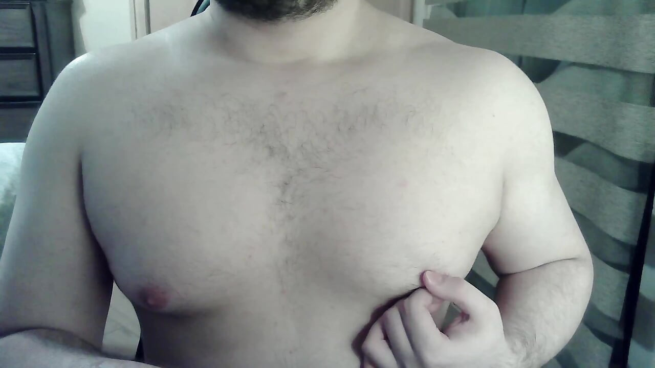 Muscular camboy flexes his muscles and squats