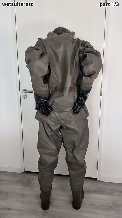Putting on Zodiac Zodiak heavy rubber hazmat suit over plastic pants and gas mask