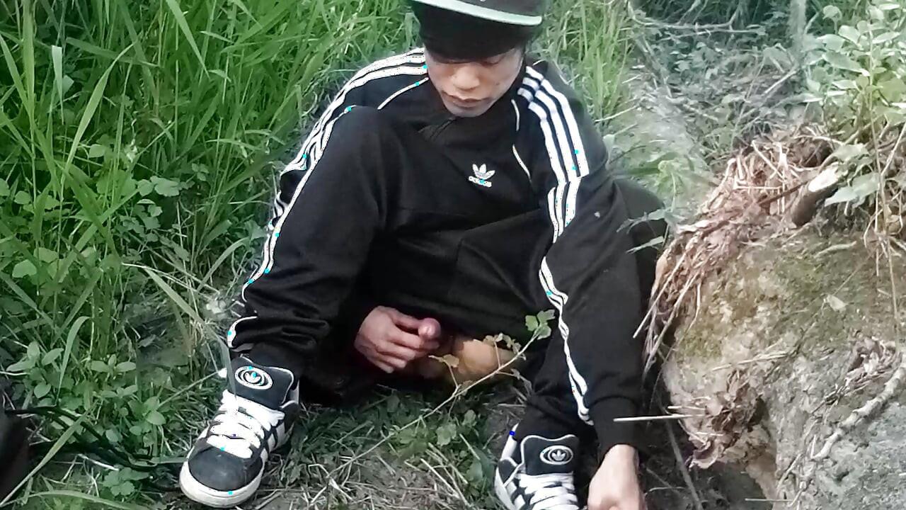 Cute Asian gay twink in a black-and-white adidas tracksuit and Campus sneakers masturbates and cums outdoors