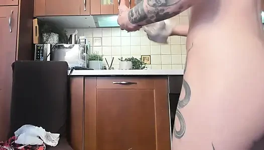 With gentle fingers, the babe fucked her ass and pussy in front of everyone present in the kitchen at the party