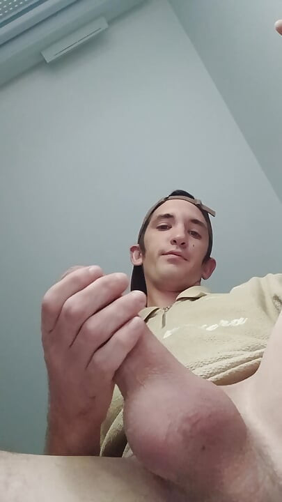 Young guy jerks off his big cock and cums
