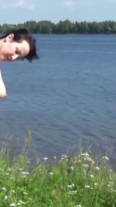 Beautiful naked walk in the wild: Naturist posing in a green spring field | Clip 1