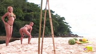 After partying on a beach these blondes use a big sex toy on each other