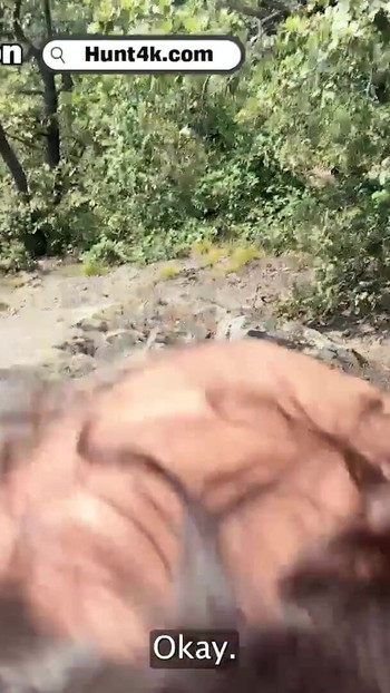 Captivating moment from "HUNT4K. Humiliating her boyfriend while sucking a huge biker's cock in the forest"