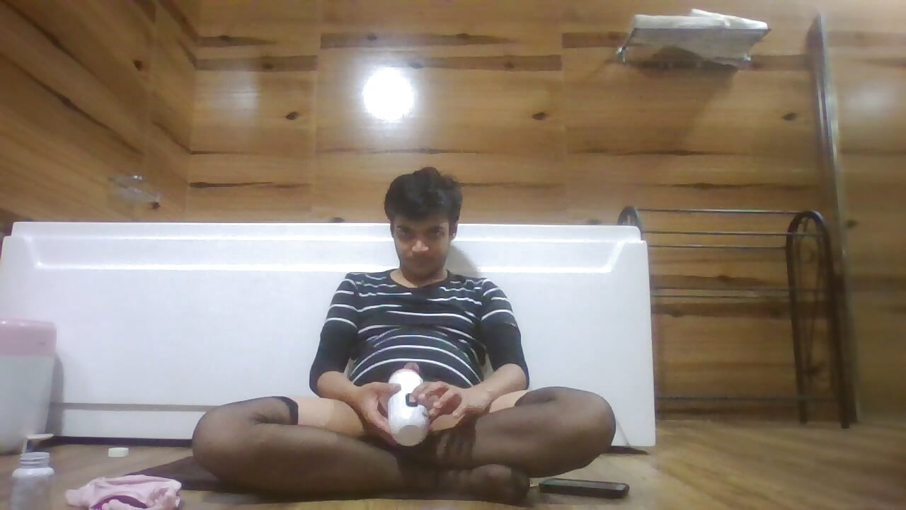 Sexy Sissy in Pantyhose Plays with Pocket Pussy while half naked and watching porn on her phone