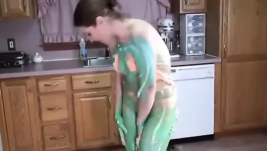 Cute slut with perky tits exhibits her body as colorful art on kitchen floor
