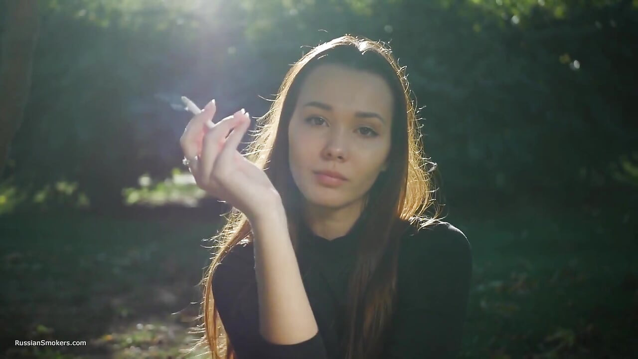 Svůdná ruská kráska kouří cigarety venku vibruje