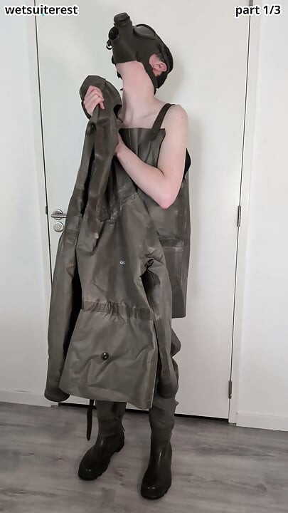 Putting on Zodiac Zodiak heavy rubber hazmat suit over plastic pants and gas mask