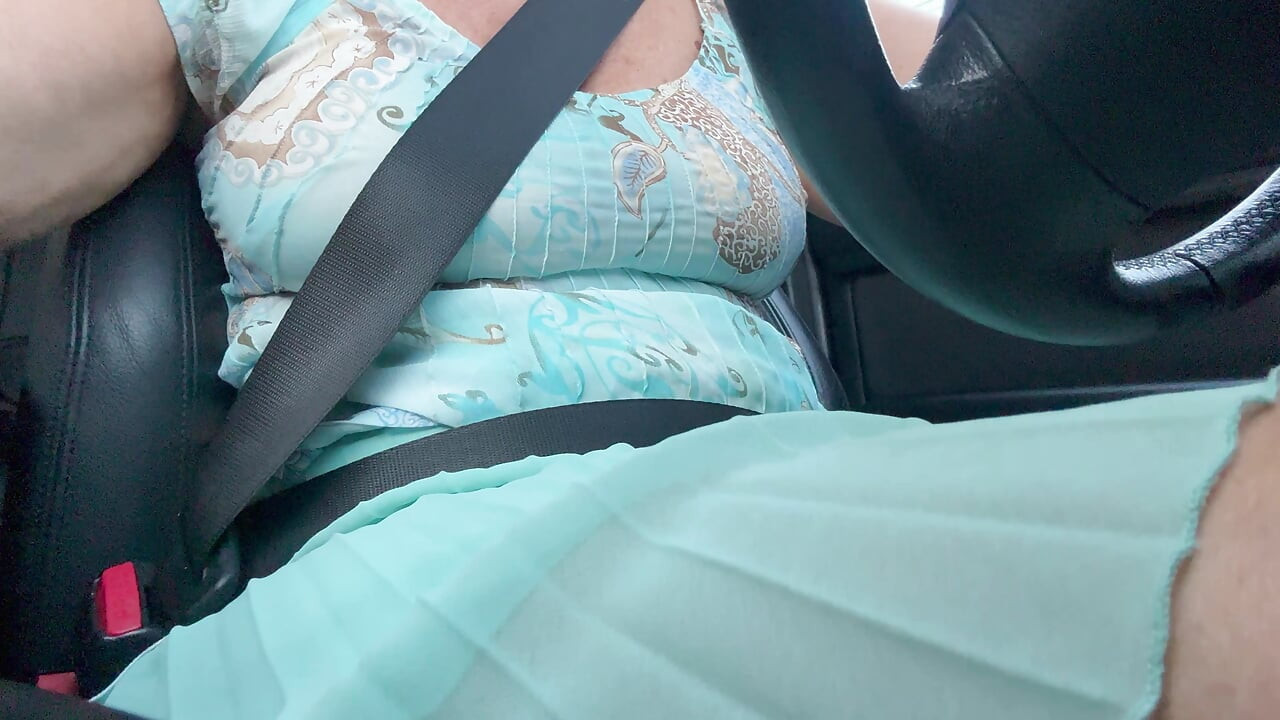 An elegant lady drives to work and rubs her pussy with her hand between her hot thighs