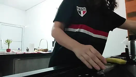 Woman teasing while washing dishes. She loves to transmit to the voyeurs on duty