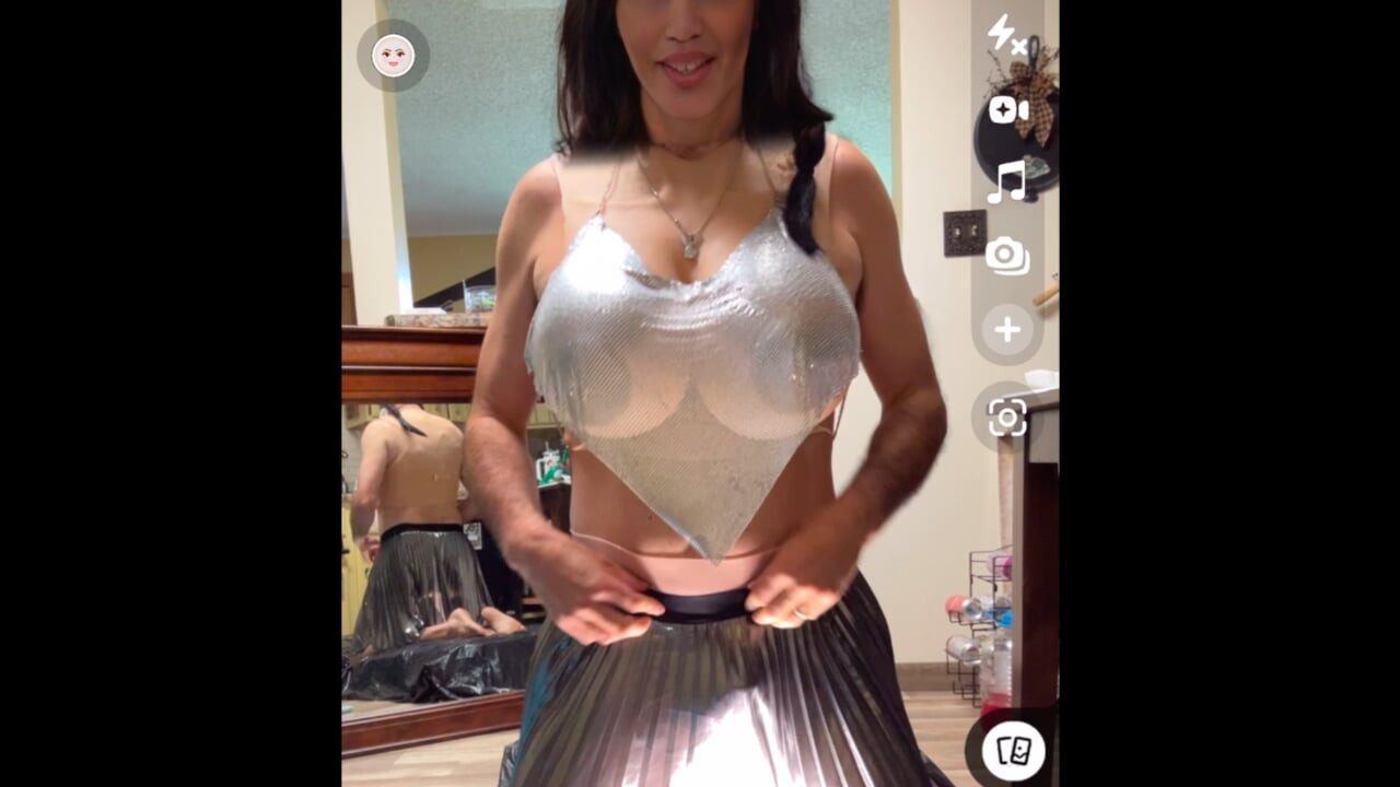 Shemale wearing see-through chainmail top shows off her nice rack