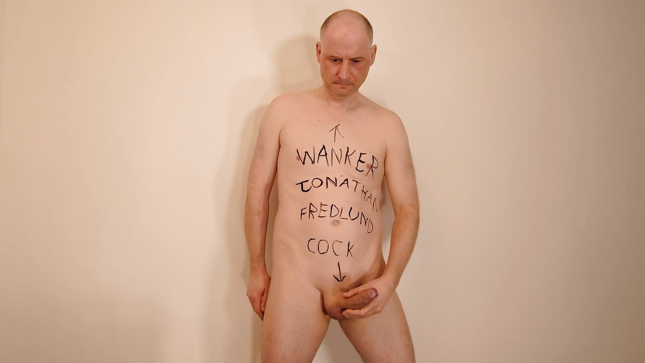 Jonathan writes cock, wanker and name on his shaved body and masturbates his uncut erect dick as he paints on himself