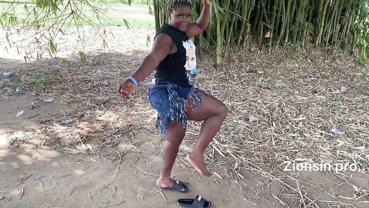 Ebony sexy black girl dances in outdoor with much laughter