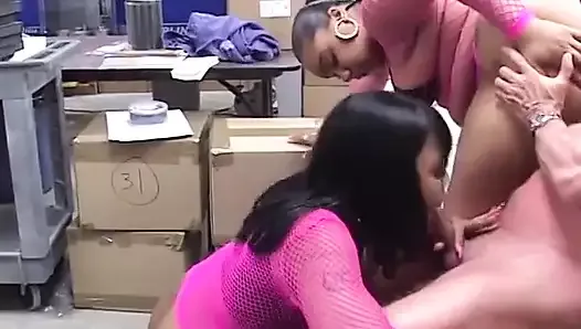 Two hungry ebony MILFs in fishnets share white dude's cock in an office