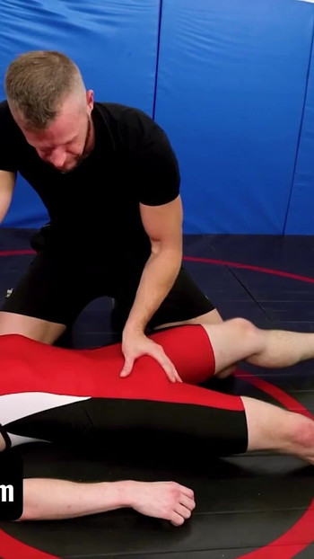 Captivating moment from "Varsity Grip - Hunk Coach Brian Bonds Drills Young Twink Wrestler In Spandex After Practice"