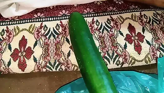 Aunty drains the water from the cucumber while relishing the cucumber to the fullest.