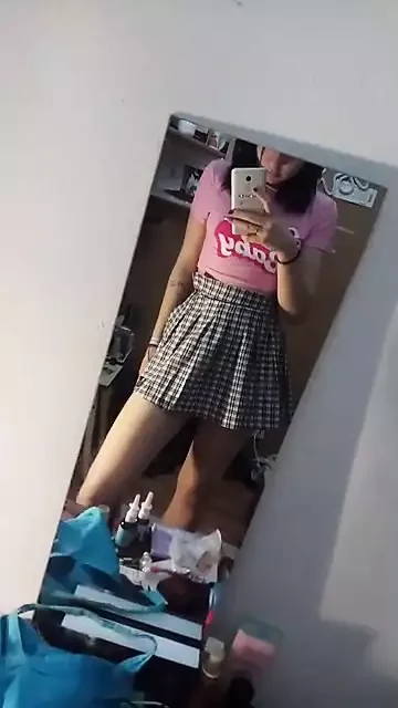 Afternoon home striptease in front of a mirror in a pink t-shirt