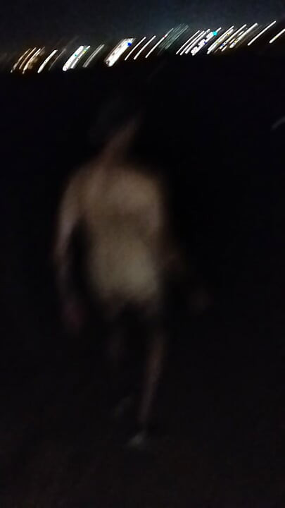 Naked walking on the hill along highway