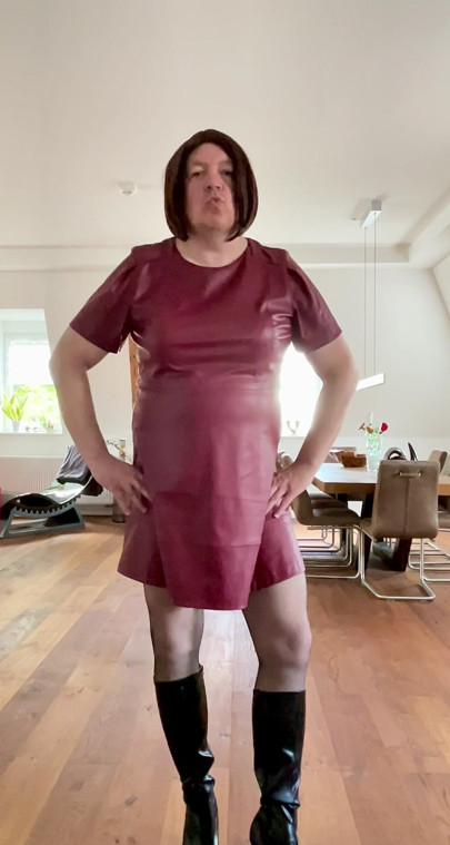 Nicolette in a sexy leather dress and platform high-heel boots