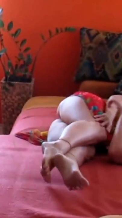 Selena's clothed unclothed posing in a pink light