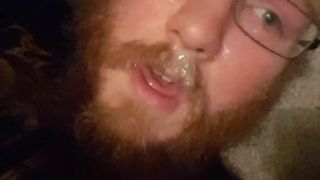 bearded boy cums all over his face