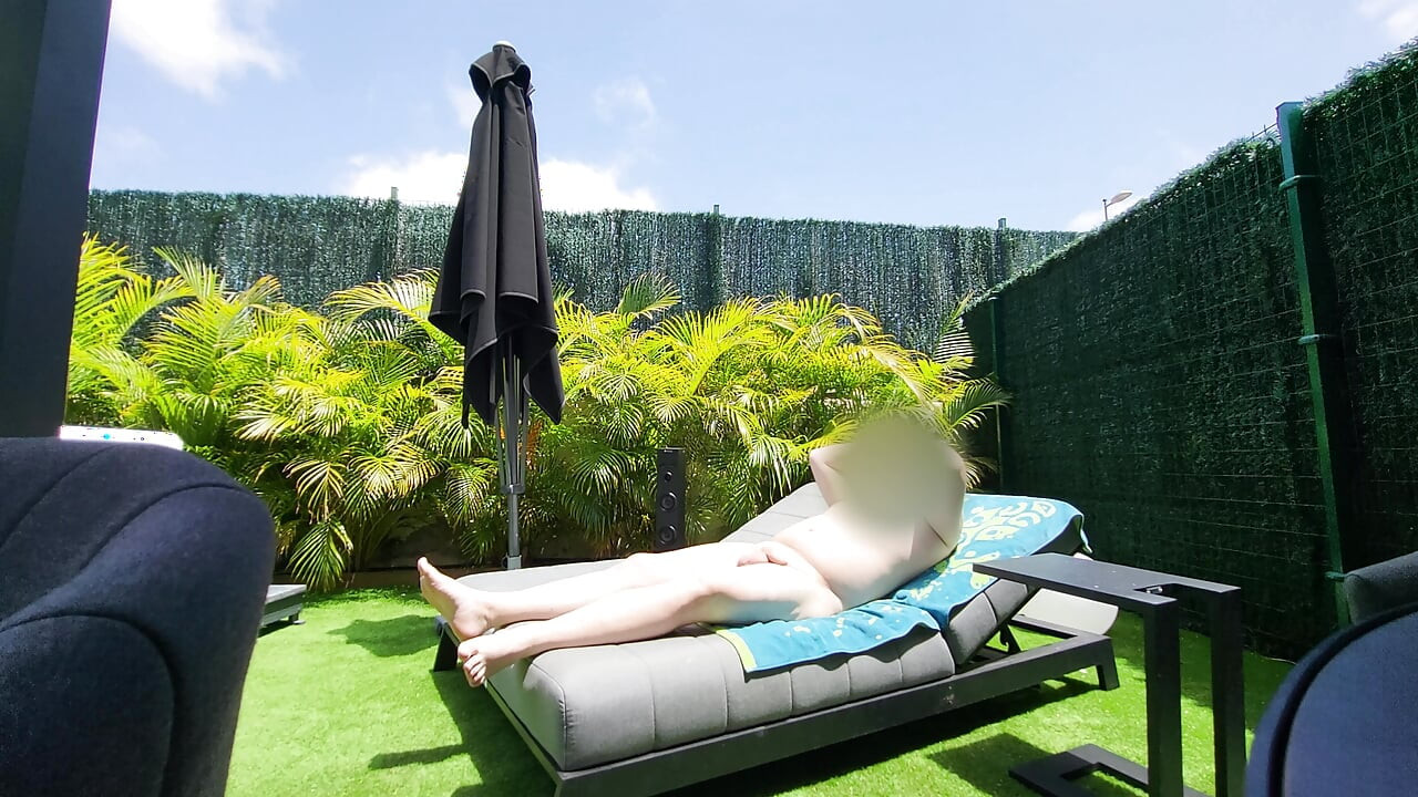 Nude guy lay on a sunlounger