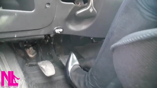 Siyah külotlu çorap ve gri patentli yüksek topuklu ayakkabılarla pedal pompalıyor