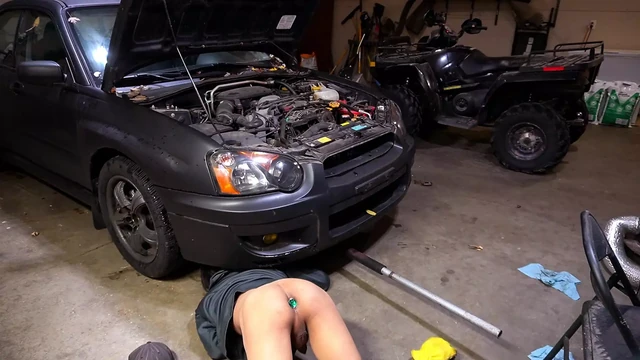 Slutty mechanic in the shop with a plug in his ass