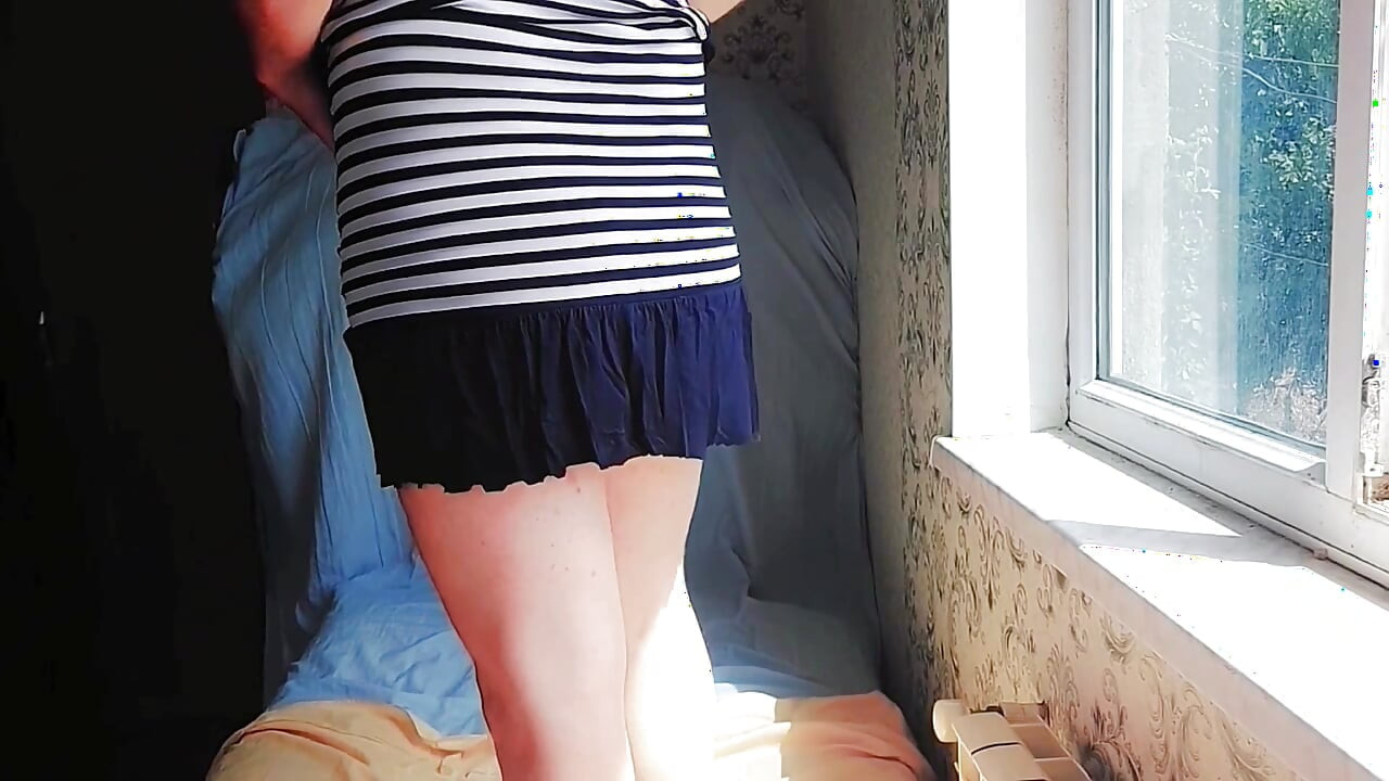 Adorable sissy posing with giant lollipop in bed