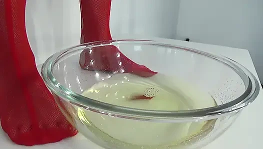 A MILF in Red Is Peeing Into a Basin.