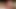 A girl with short hair is trying to completely immerse the dick in her throat