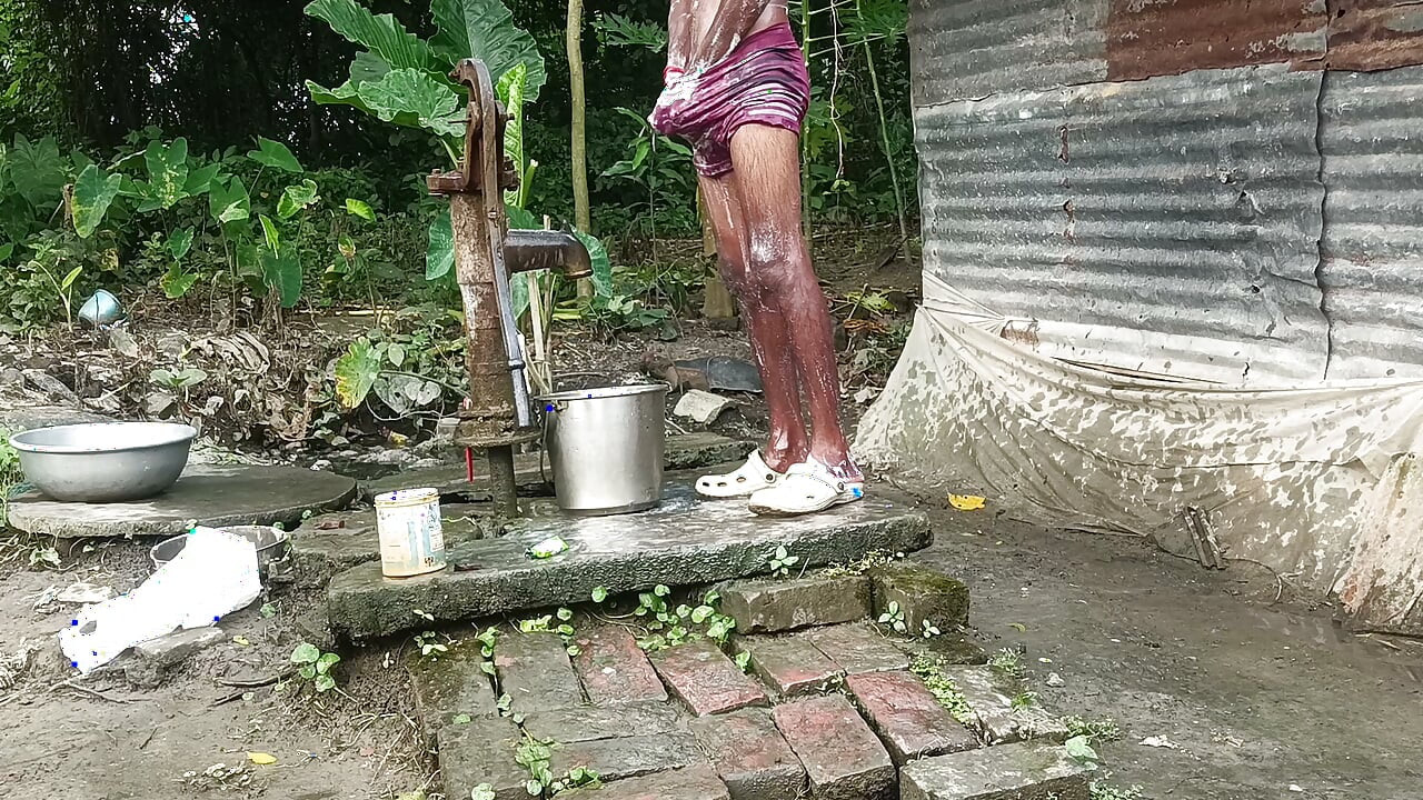 Black mature man bath in desi style. Showing big dick.