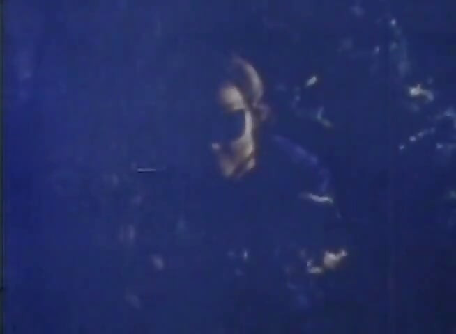 Blue-tinted Vintage Loop Shows Retro Couple in Raw 70s Action
