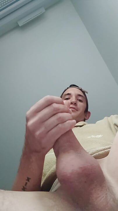 Young guy jerks off his big cock and cums