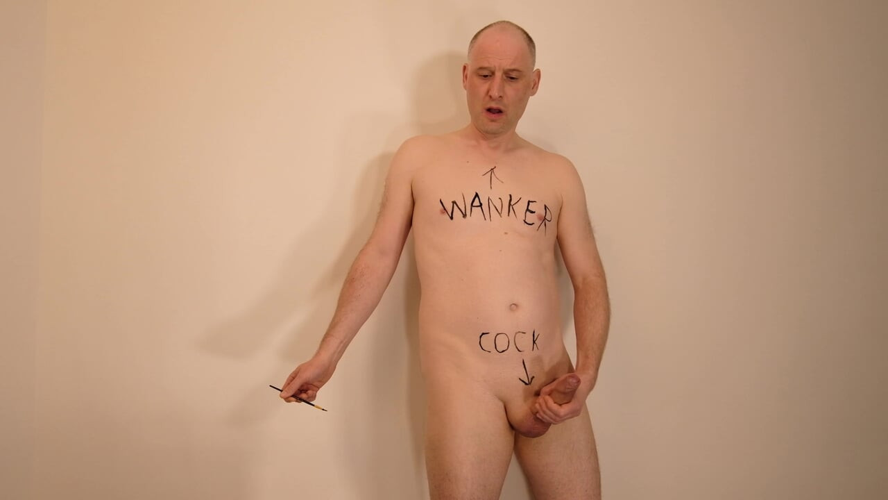 Jonathan writes cock, wanker and name on his shaved body and masturbates his uncut erect dick as he paints on himself
