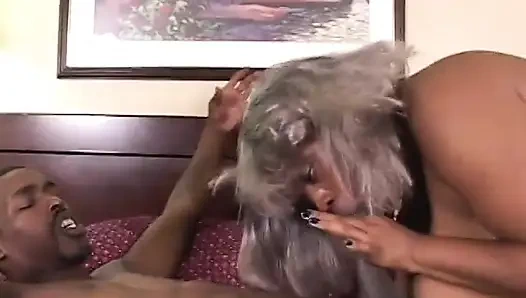 Cute black man gets his hard cock blown by a granny on the bed