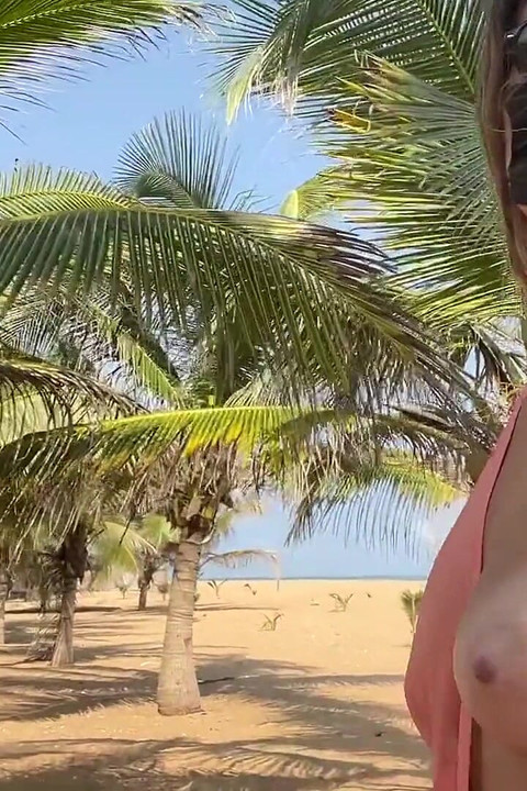 A Busty Blonde Woman Is Walking Around and Showing Her Naked Body on the Beach.