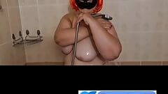 Ugly fat granny with mask takes a shower. Her saggy titts are amazing.