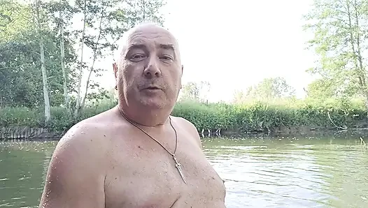 The plump, mustachioed daddy is having a blast in the stream, shamelessly masturbating with mud