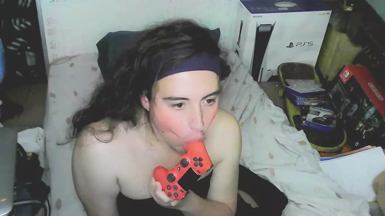Cute cd girl, beautiful eyes and face. Kissing, licking and sucking a playstation controller. Sweet cd girl next door.