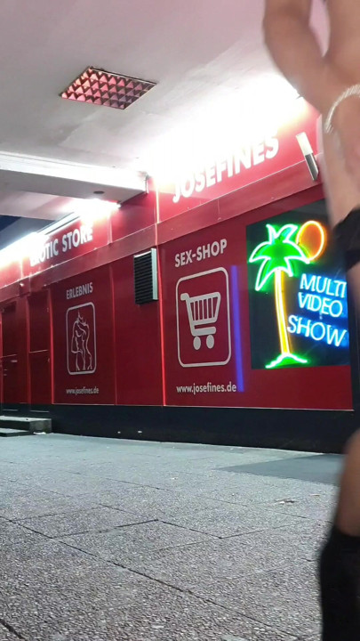 Naked in front of the porn shop