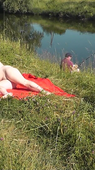 Captivating moment from "Wild beach. Sexy MILF Platinum naked sunbathing on river bank, random fisherman guy watches. Naked"