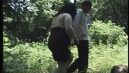 Mature brunette with big tits fucks outdoors