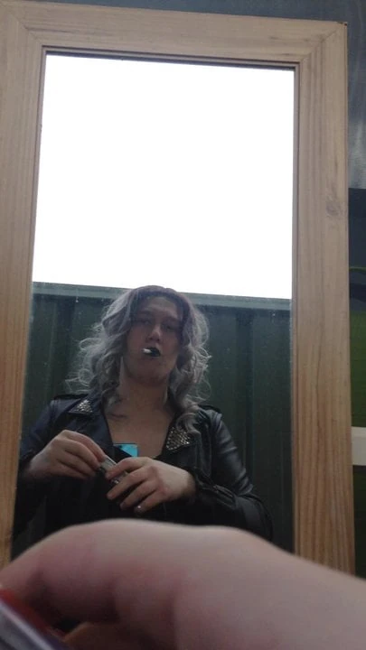 Sissy crossdresser smoking in leather