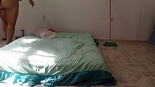 Mexican mother-in-law cleaning guest room in thong