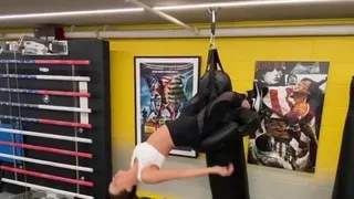 Kate Beckinsale clinging to punching bag with her legs