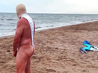 My husband in a chastity cage is exposed on a beach