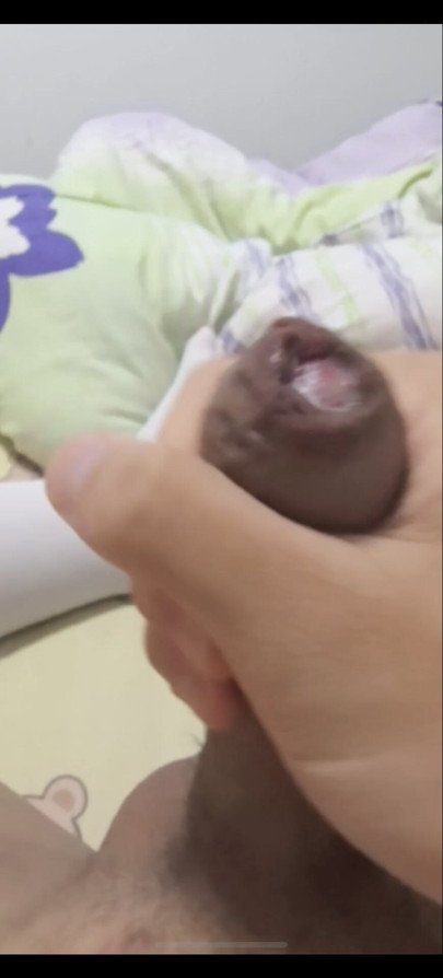 The young man masturbates at home wearing stockings, playing with his cute penis until he ejaculates